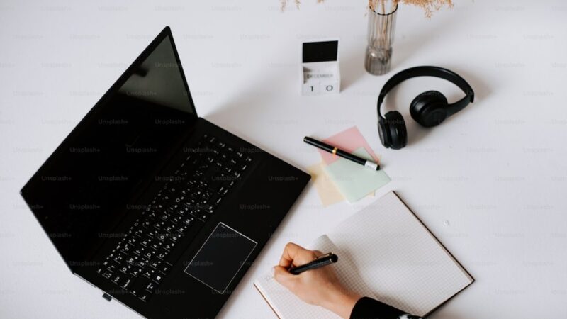 a laptop computer sitting on top of a white desk