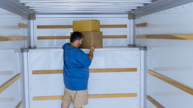 Packages delivery cardboard boxes on transportation system in car