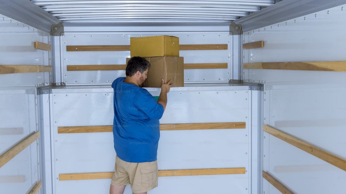 Packages delivery cardboard boxes on transportation system in car