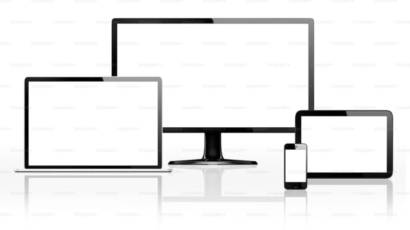 Various electronic devices with blank screens on white.