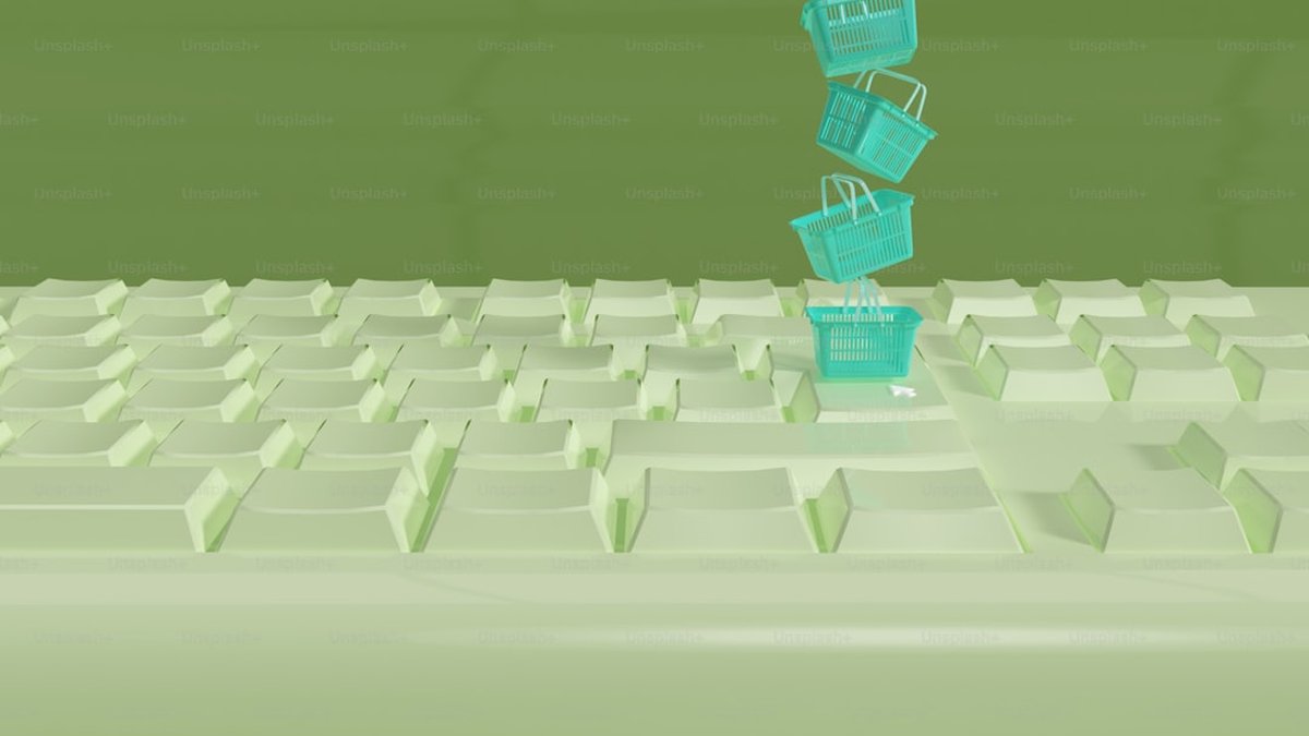 a computer keyboard with a shopping basket on top of it